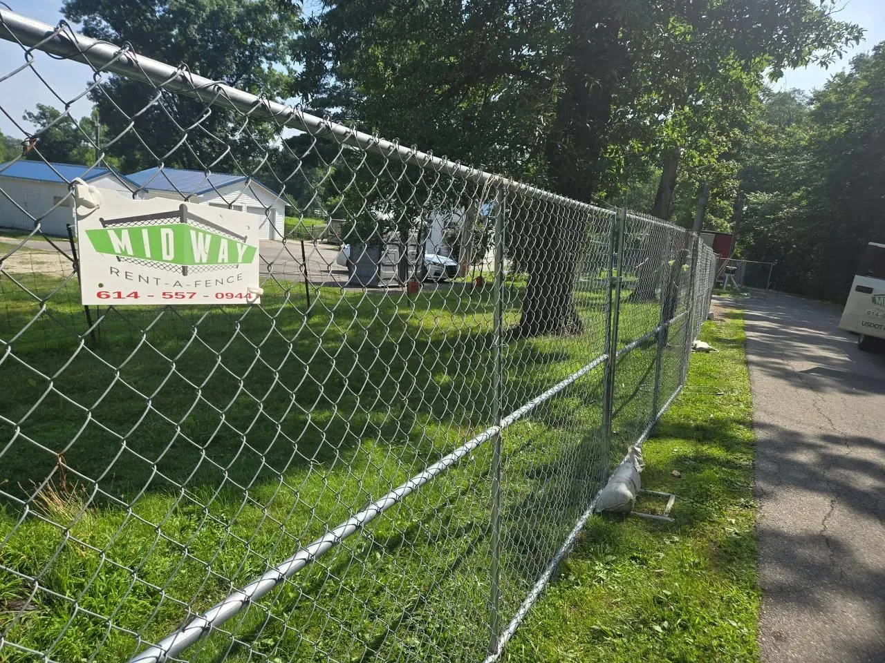 6-foot panels with sandbag reinforcement — Midway Rent-A-Fence